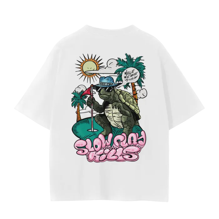 A white crew neck t-shirt with a graphic print of a turtle in a sun hat and sunglasses, playing a game of golf, and the text 'SLOW PLAY KILLS' below it.