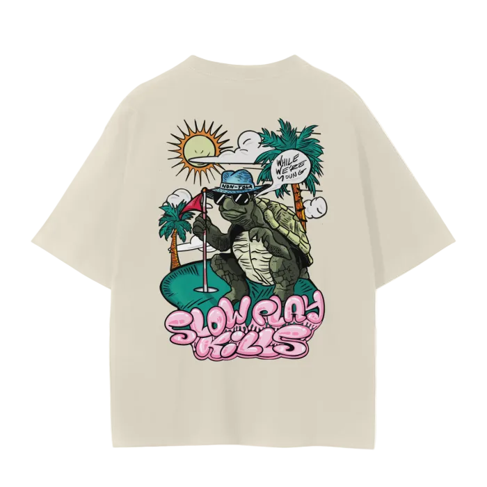 A white crew neck t-shirt with a graphic print of a turtle in a sun hat and sunglasses, playing a game of golf, and the text 'SLOW PLAY KILLS' below it.