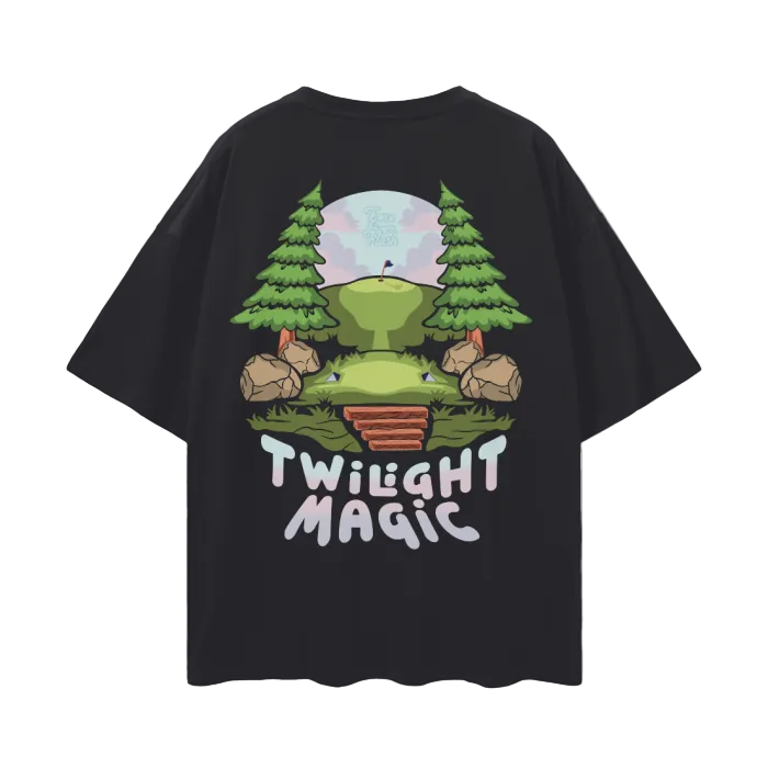 A black t-shirt with a graphic design featuring a stylized golf course with trees, a tee box, and a sink hole, with the text 'TWILIGHT MAGIC' across the front.