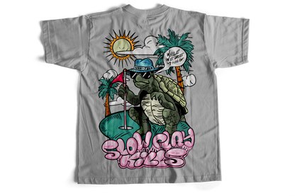 Gray t-shirt with a graphic of a turtle playing golf on a beach, featuring text and palm trees.